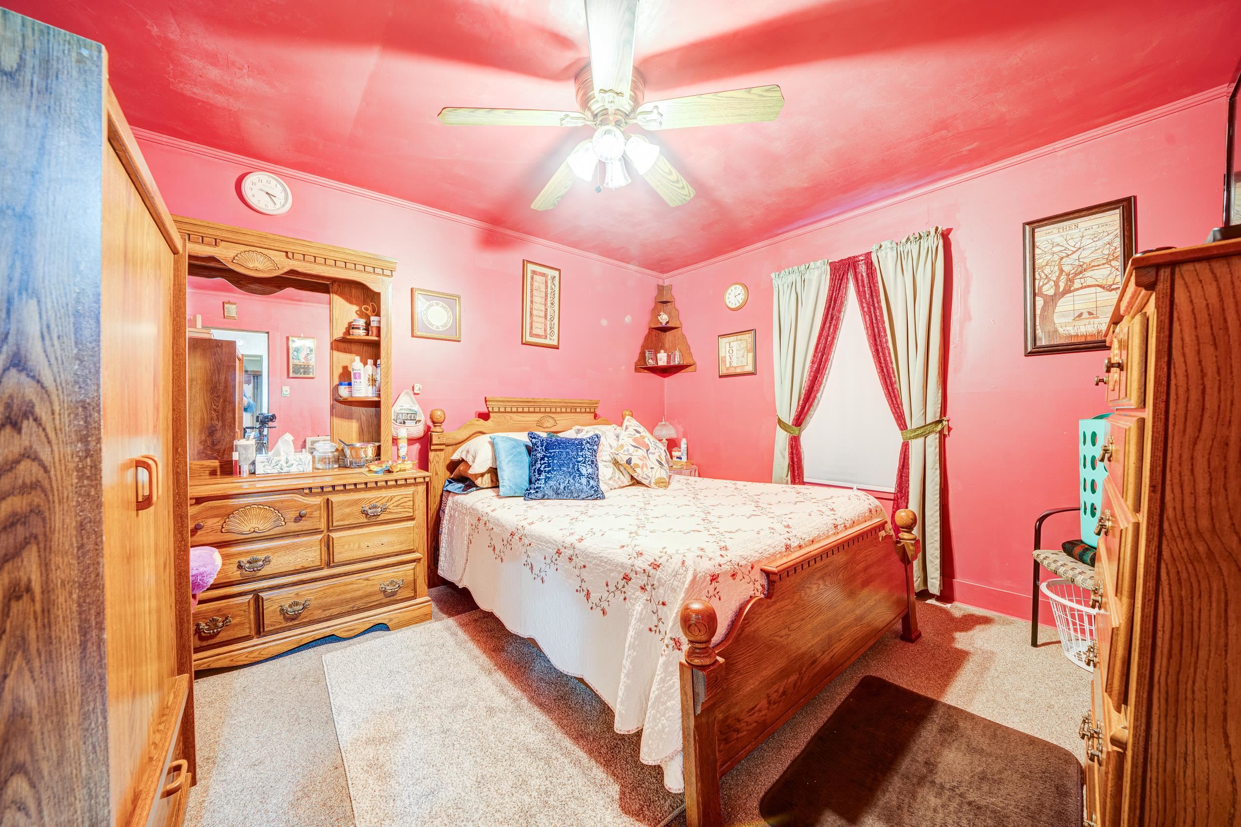 24315 Highway 76 Somerville, TN 38068 - Photo 9 of 27 a bedroom with a bed and a chandelier