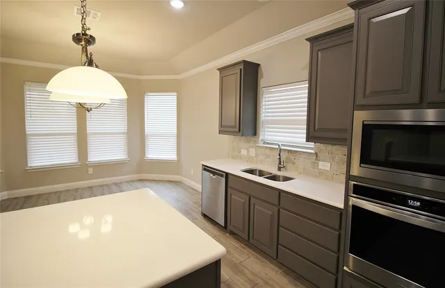 a kitchen with a sink a window and appliances