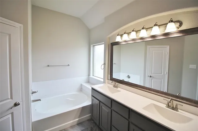 a bathroom with a bathtub and a sink