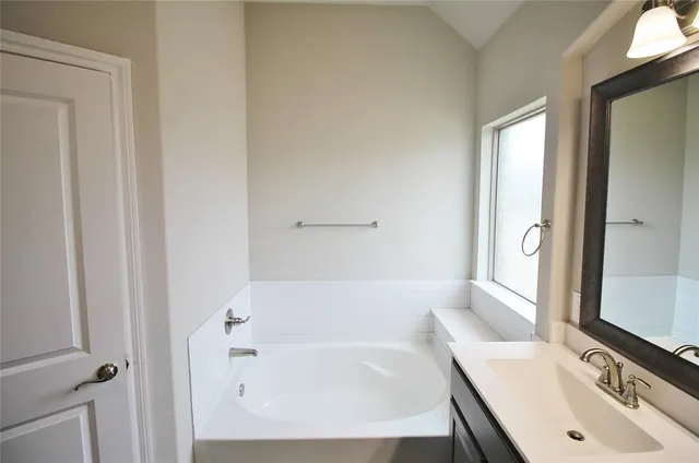 a bathroom with a bathtub and a sink