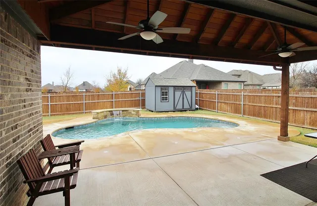 a view of a patio with a table and chairs