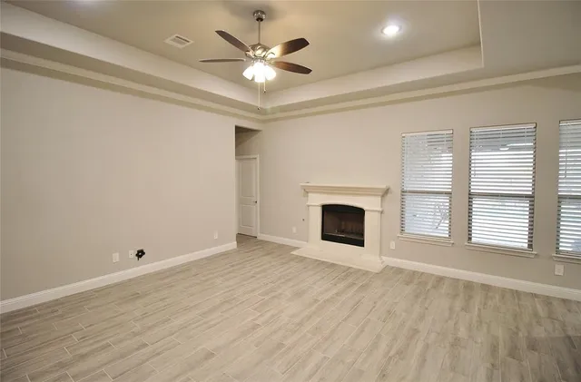 wooden floor in an empty room with a fireplace