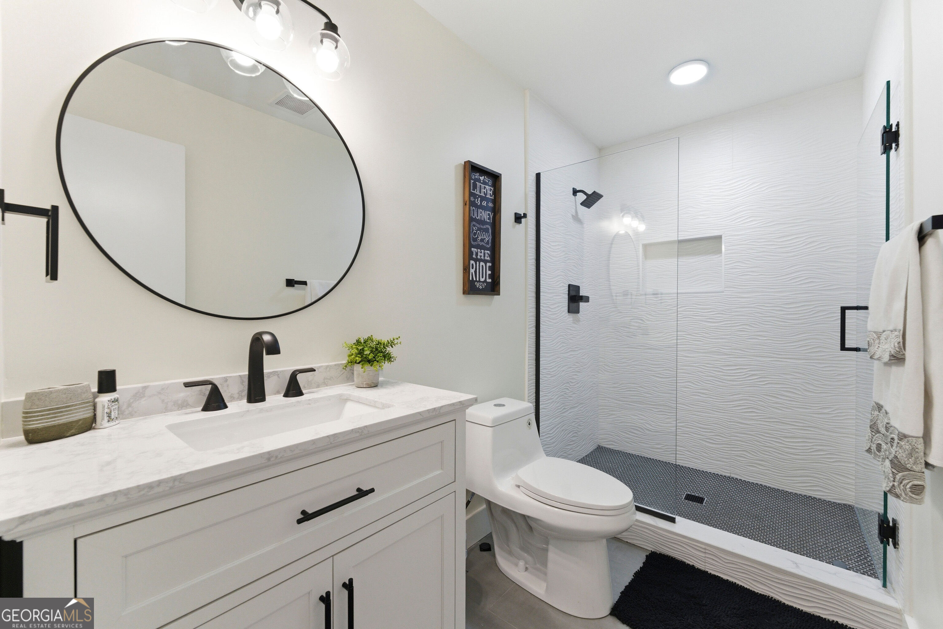 2704 Long Lake Drive Northeast Roswell, GA 30075 - Photo 27 of 48 a bathroom with a sink a toilet and a mirror