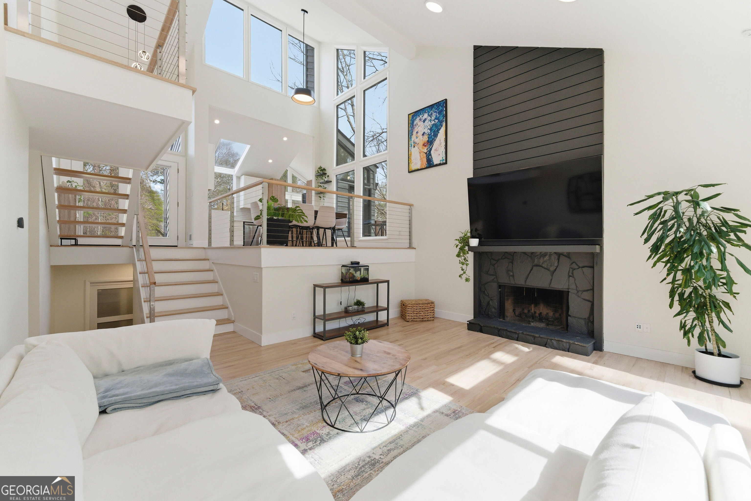 2704 Long Lake Drive Northeast Roswell, GA 30075 - Photo 3 of 48 a living room with furniture a fireplace and a flat screen tv