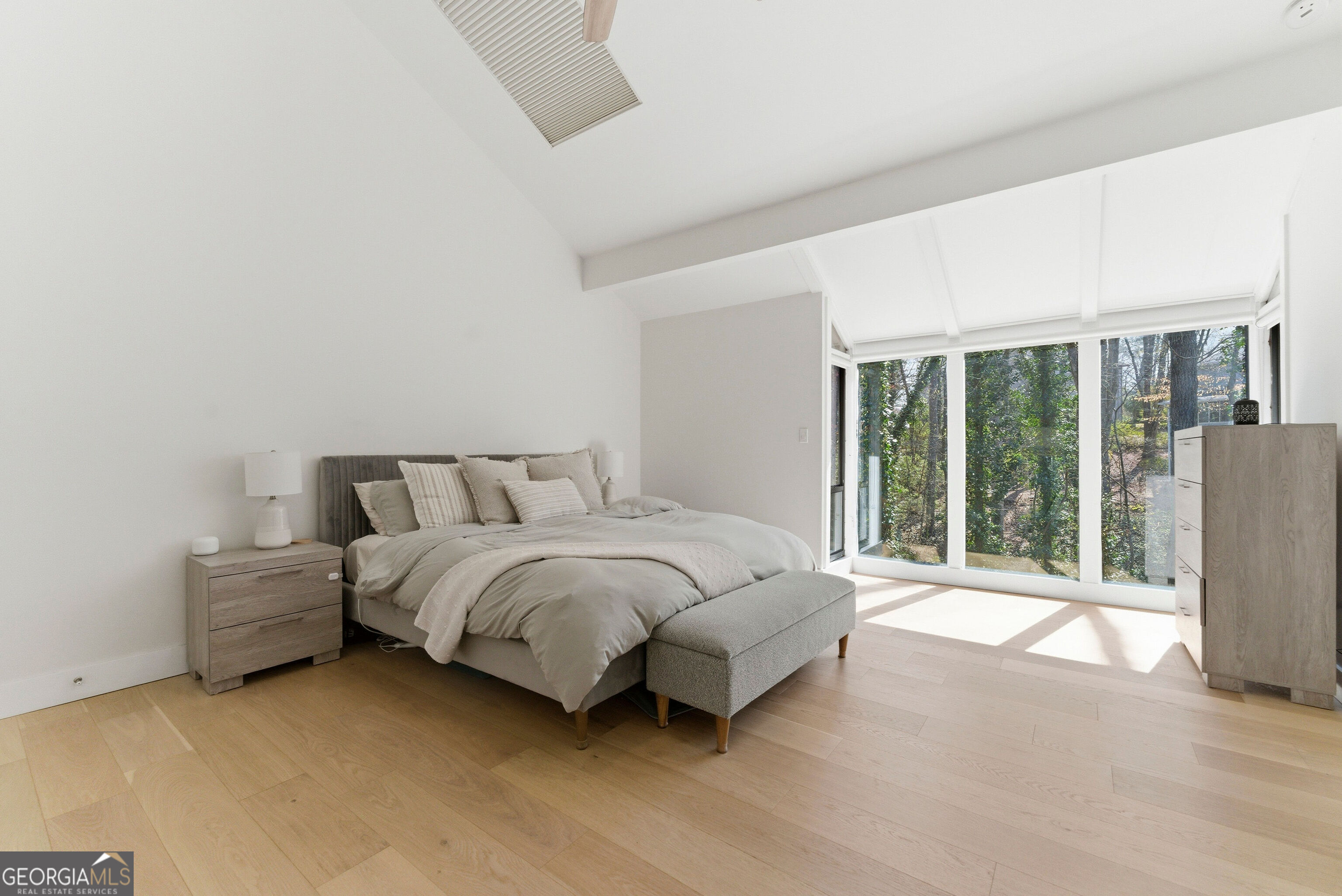 2704 Long Lake Drive Northeast Roswell, GA 30075 - Photo 38 of 48 a spacious bedroom with a bed and a large window