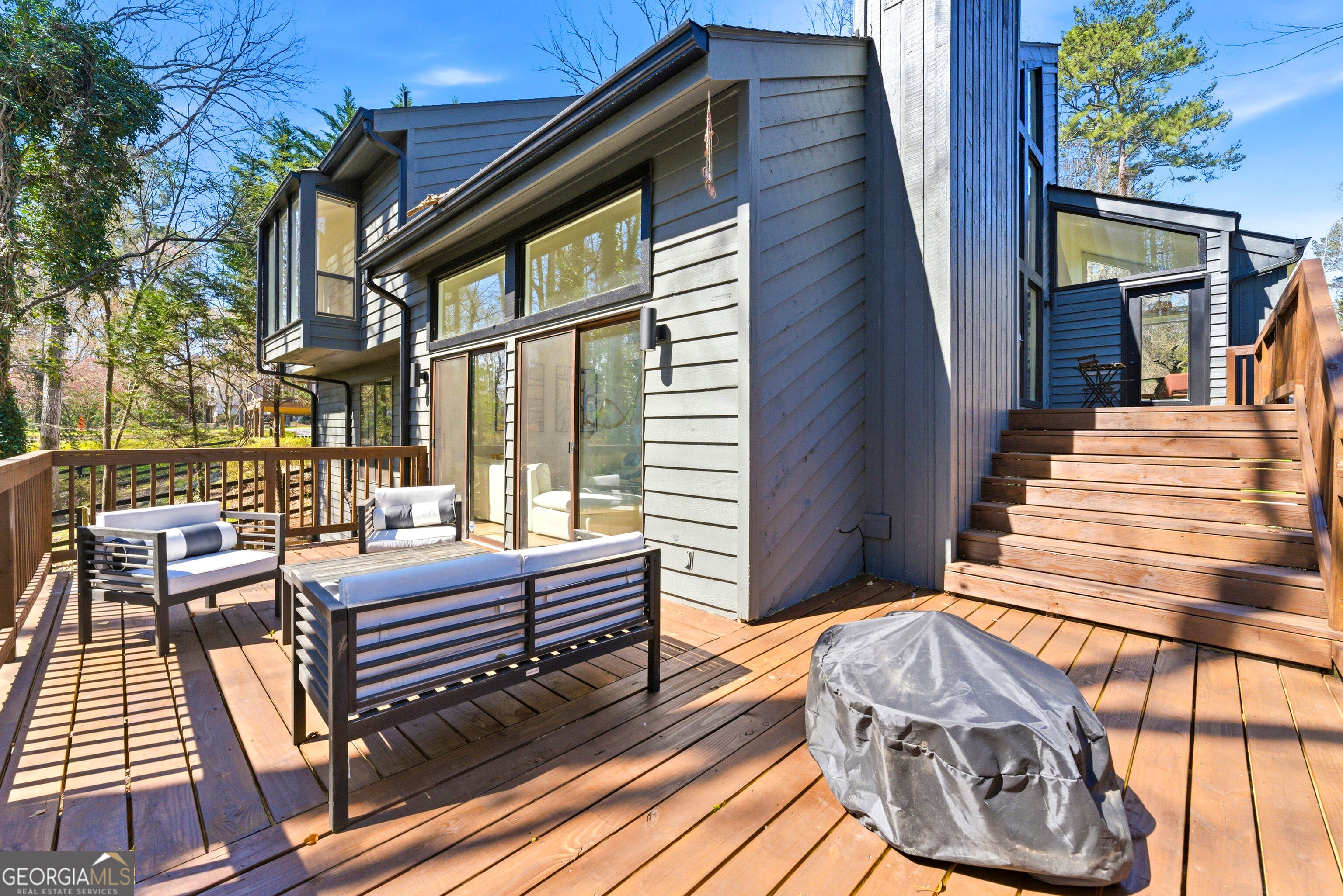 2704 Long Lake Drive Northeast Roswell, GA 30075 - Photo 46 of 48 a view of a patio with couches table and chairs and wooden floor