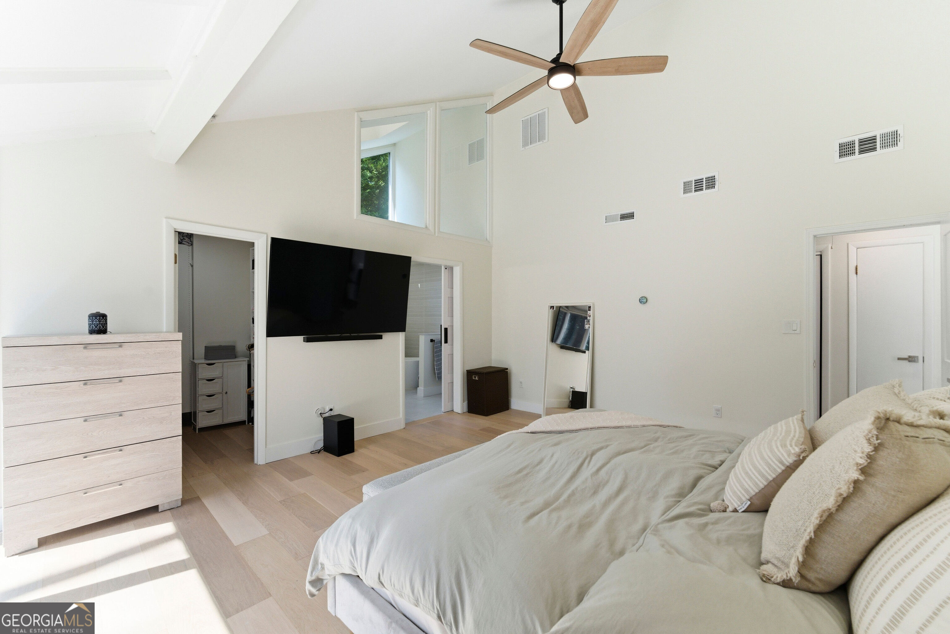 2704 Long Lake Drive Northeast Roswell, GA 30075 - Photo 5 of 48 a bedroom with a bed a window and a flat screen tv