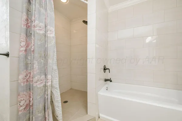 a bathroom with a bathtub and shower