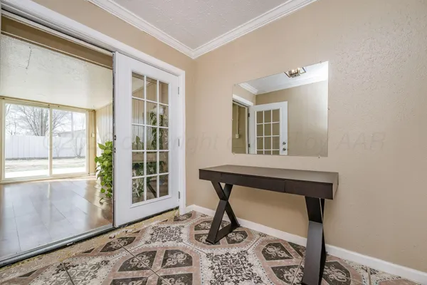 a living room with a black chair and a large window