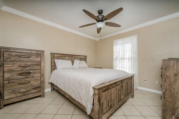 a bedroom with a bed and a ceiling fan