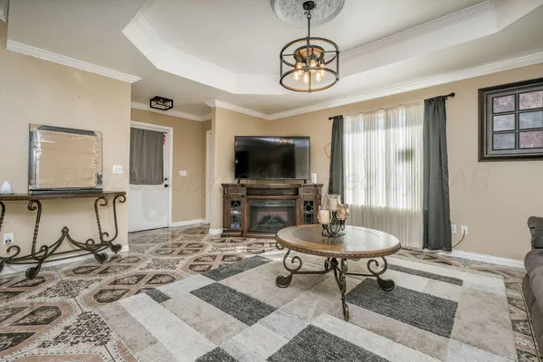 a living room with couch a dining table and a flat screen tv