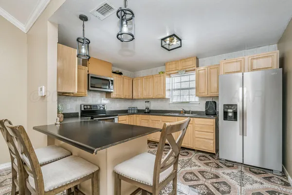 a kitchen with refrigerator cabinets dining table and chairs