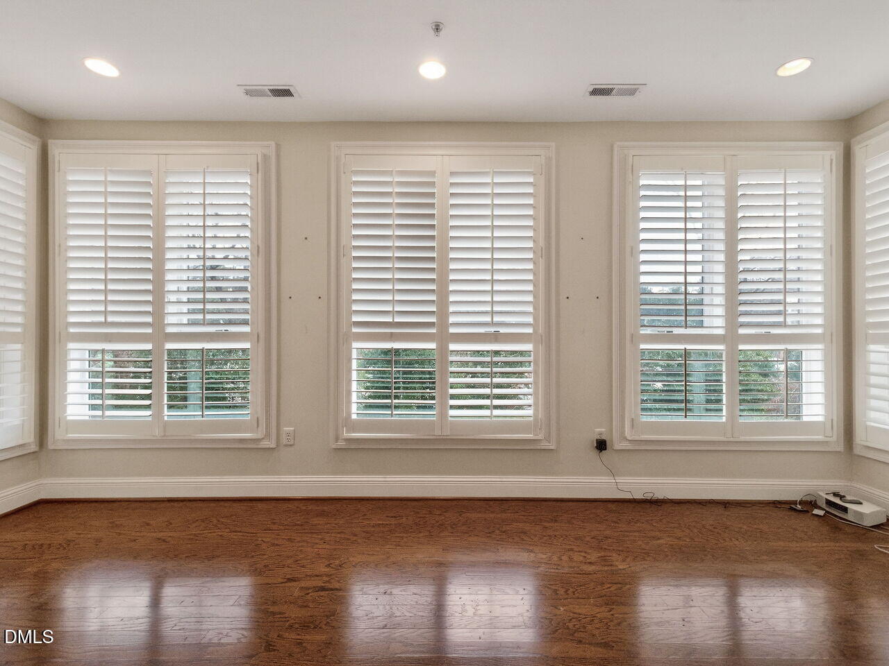 2901 Market Bridge Lane, Unit 104 Raleigh, NC 27608 - Photo 17 of 45 a view of an empty room with wooden floor and a window