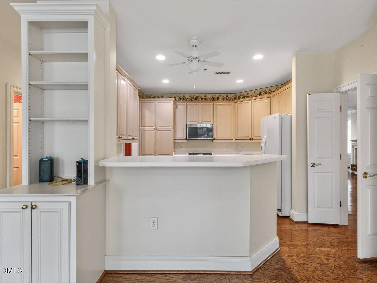 2901 Market Bridge Lane, Unit 104 Raleigh, NC 27608 - Photo 21 of 45 a kitchen with kitchen island a sink stainless steel appliances and cabinets