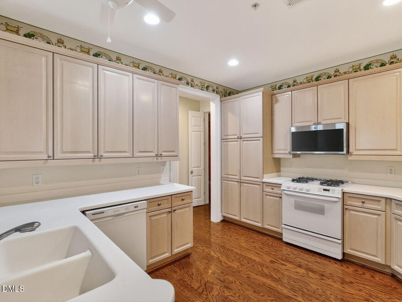 2901 Market Bridge Lane, Unit 104 Raleigh, NC 27608 - Photo 23 of 45 a kitchen with a sink cabinets and stainless steel appliances