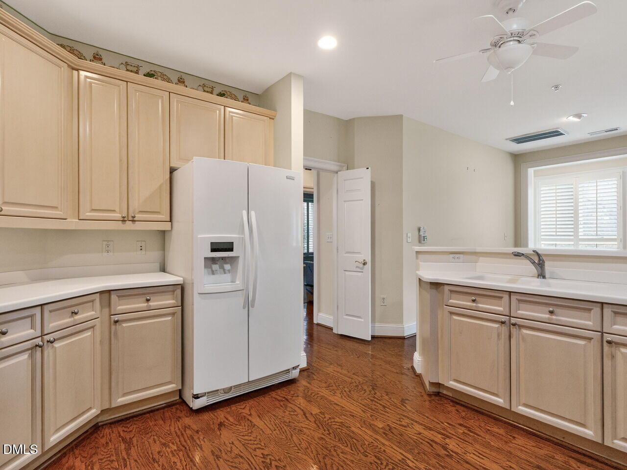 2901 Market Bridge Lane, Unit 104 Raleigh, NC 27608 - Photo 24 of 45 a kitchen with white cabinets and refrigerator