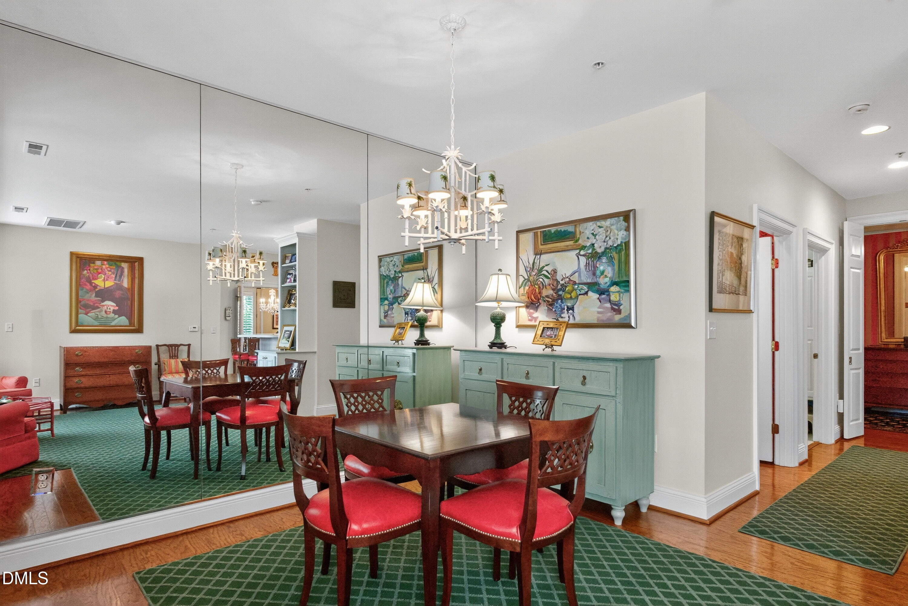 2901 Market Bridge Lane, Unit 104 Raleigh, NC 27608 - Photo 26 of 45 a dining room with furniture a rug and a chandelier
