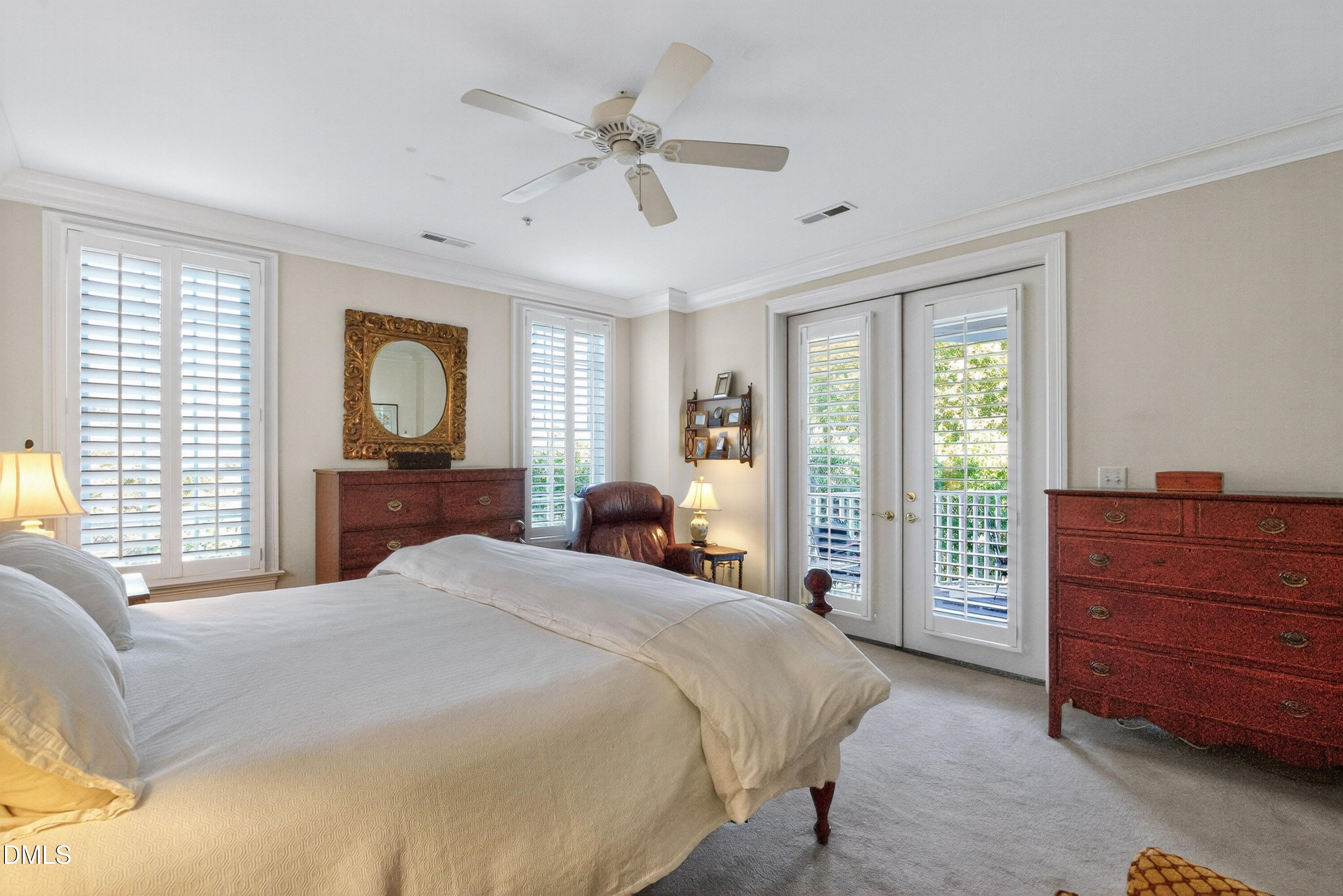 2901 Market Bridge Lane, Unit 104 Raleigh, NC 27608 - Photo 30 of 45 a bedroom with a large bed and a dresser