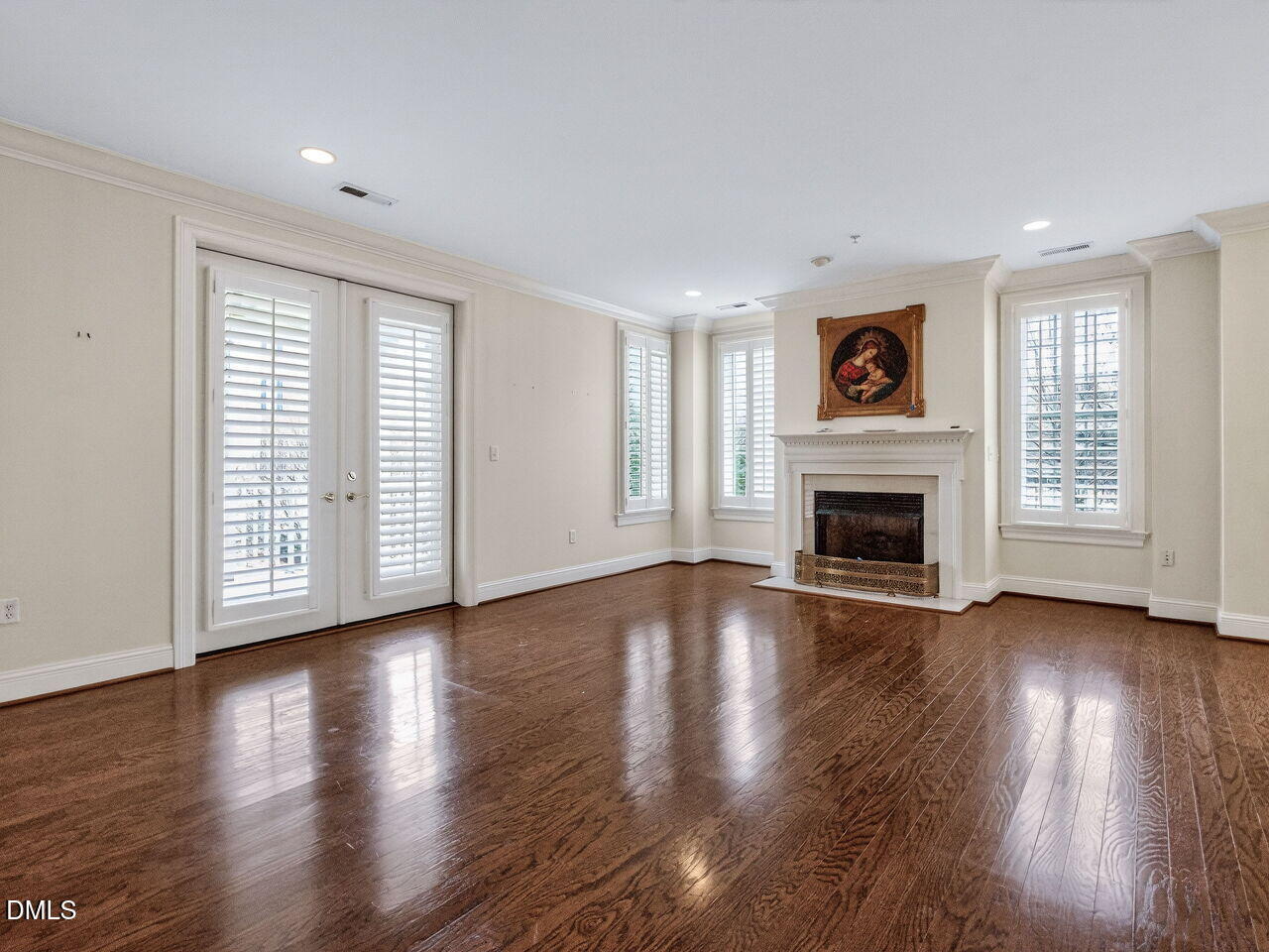 2901 Market Bridge Lane, Unit 104 Raleigh, NC 27608 - Photo 6 of 45 an empty room with wooden floor and fireplace
