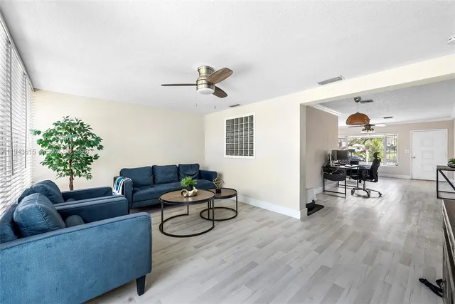 a living room with furniture and wooden floor