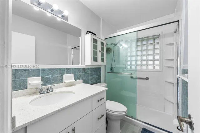 a bathroom with a sink toilet and shower
