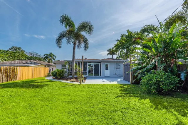 a view of a house with a yard and a patio