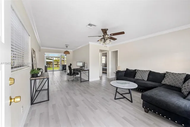 a living room with furniture and wooden floor