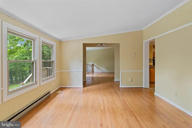 wooden floor in an empty room with a window