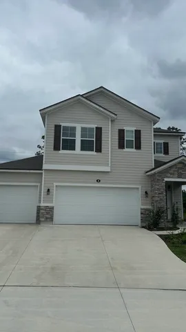 a front view of a house with garage