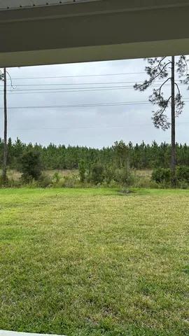 a view of a field with an ocean view