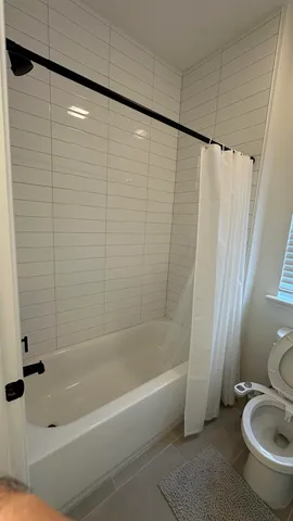 a bathroom with a shower and a toilet