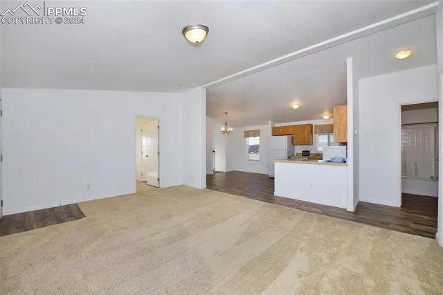 a view of a kitchen with a sink and a refrigerator