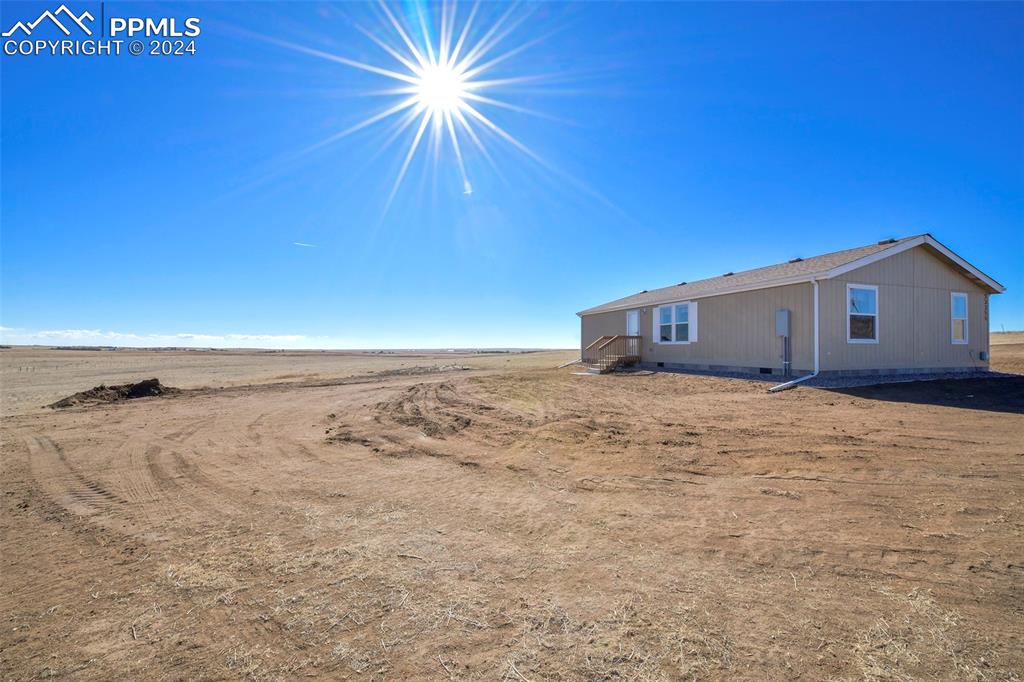 33355 Berndt Road Yoder, CO 80864 - Photo 4 of 26 a view of a house with a backyard