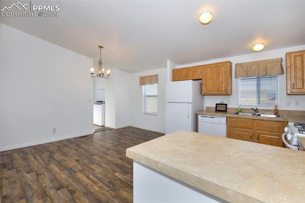 33355 Berndt Road Yoder, CO 80864 - Photo 8 of 26 a kitchen with a refrigerator a sink dishwasher with a dining table and chairs