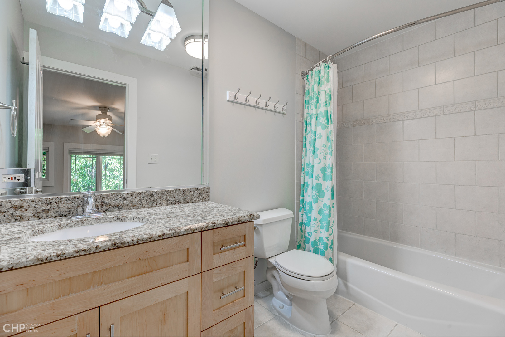 275 Lawton Road Riverside, IL 60546 - Photo 23 of 35 a bathroom with a granite countertop toilet a sink and a bathtub