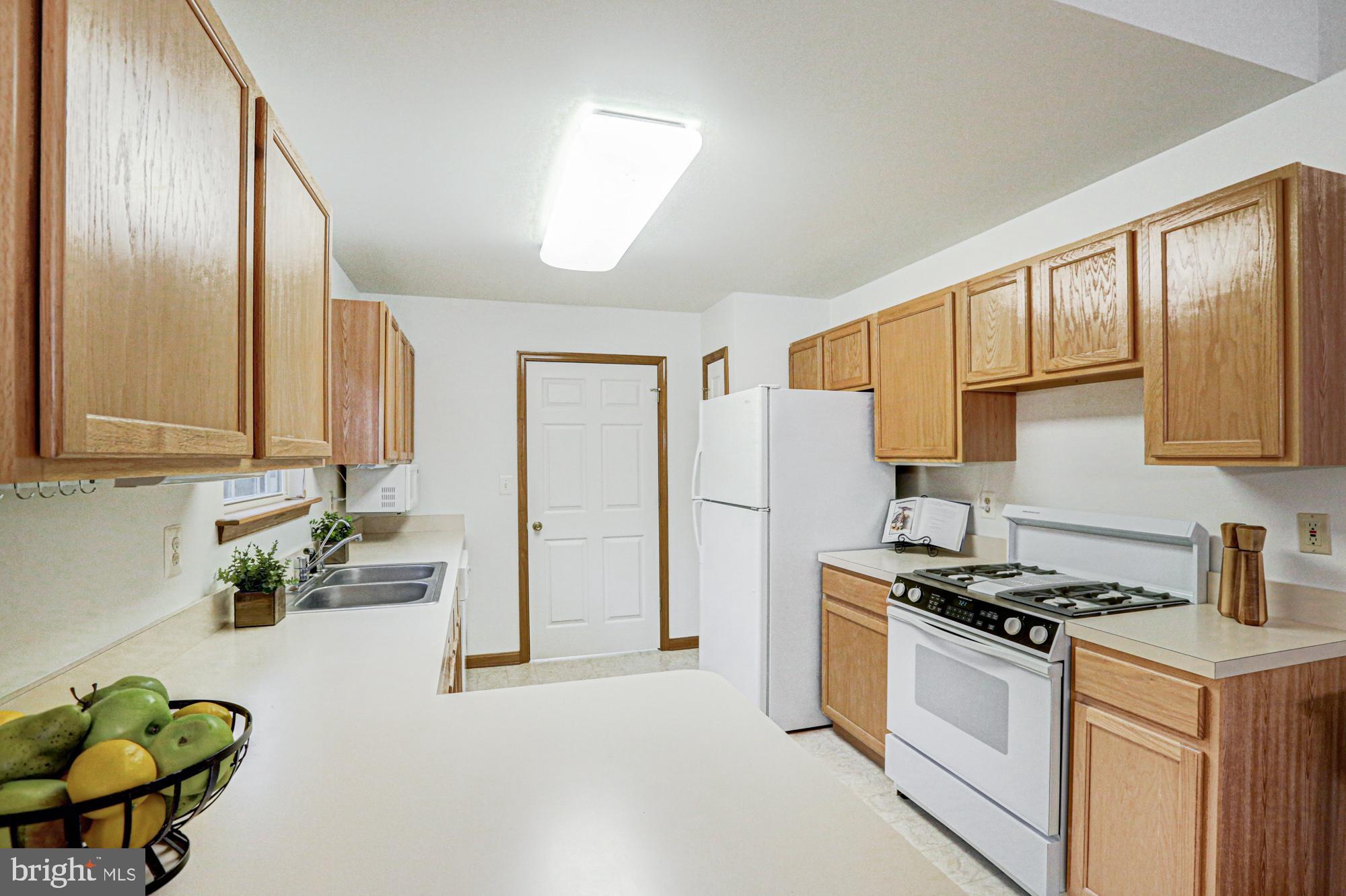 230 Tina Marie Lane Smyrna, DE 19977 - Photo 31 of 83 a kitchen with stainless steel appliances a stove a sink cabinets and a refrigerator