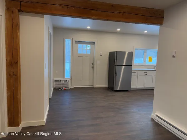 a view of a kitchen with refrigerator and microwave