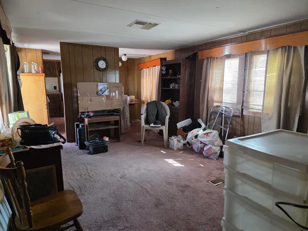 a kitchen with a refrigerator a sink and wooden cabinets