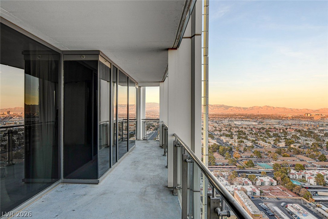 4381 West Flamingo Road, Unit 3002 Las Vegas, NV 89103 - Photo 9 of 59 Panoramic mountain and valley vistas unfold from a spacious high-rise balcony.