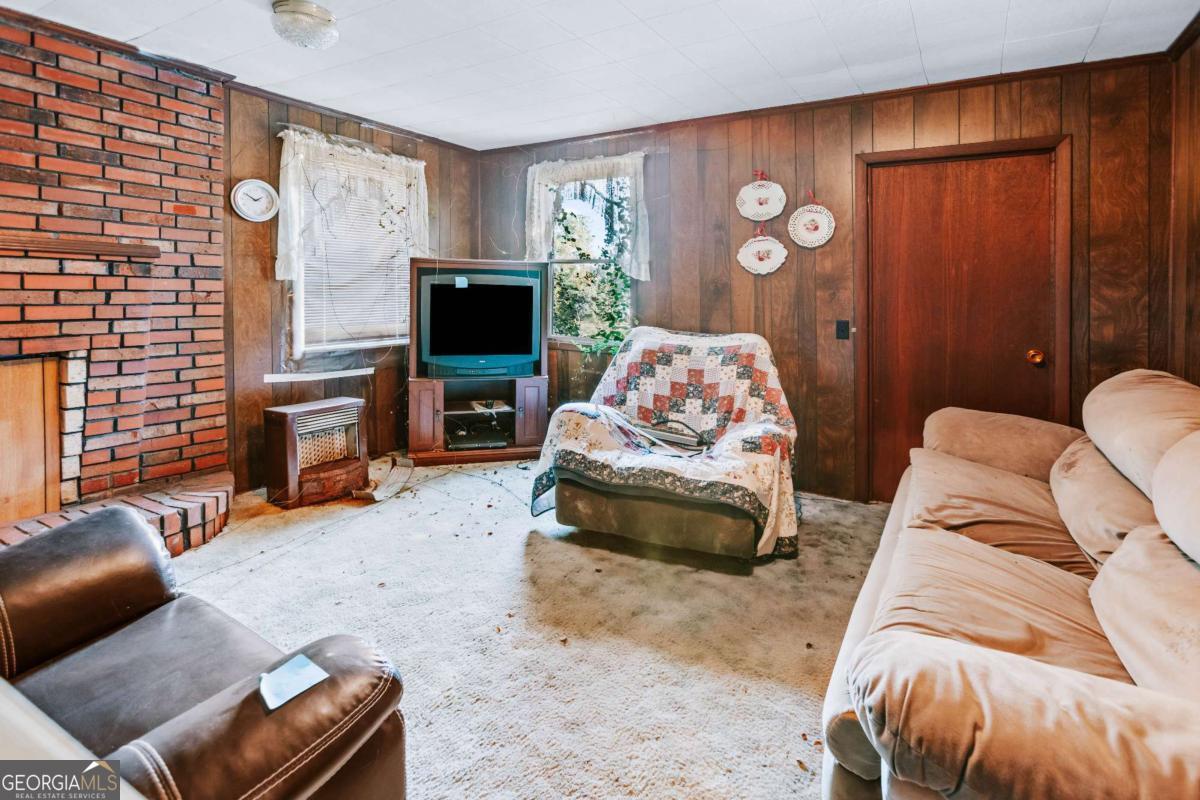 139 Wesley Chapel Road Lexington, GA 30648 - Photo 11 of 23 a living room with furniture and a fireplace