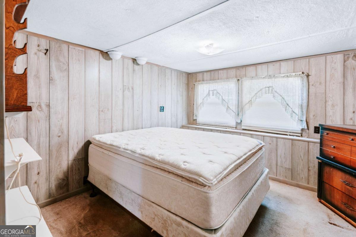 139 Wesley Chapel Road Lexington, GA 30648 - Photo 8 of 23 a living room with a bed and a window