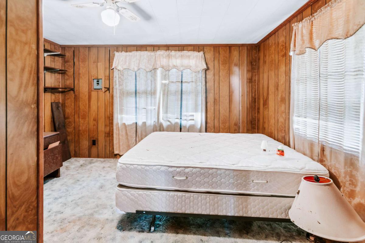 139 Wesley Chapel Road Lexington, GA 30648 - Photo 9 of 23 a large bed sitting in a bedroom next to a window