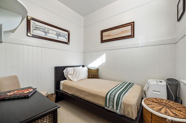 a bedroom with a bed and cupboard