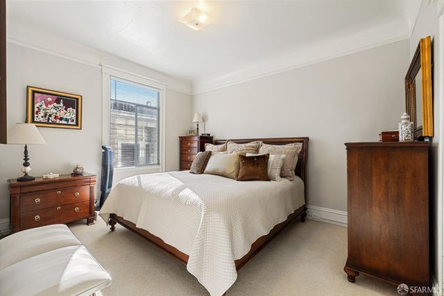 a bedroom with a bed and flat screen tv