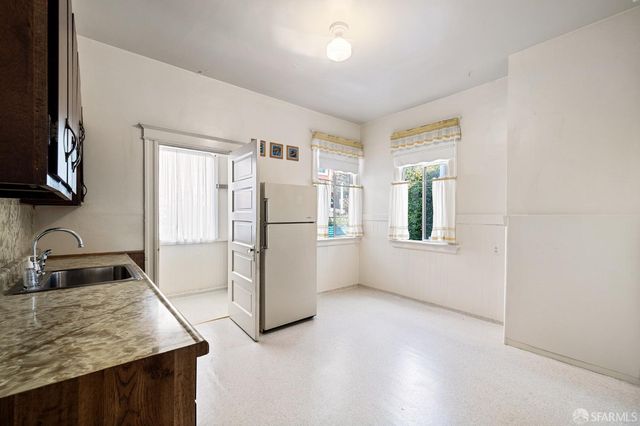 a kitchen with a refrigerator and a sink