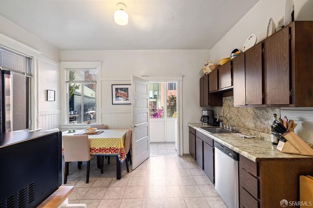 a large kitchen with a table and chairs in it