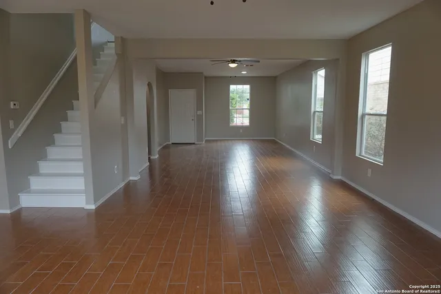 wooden floor in an empty room with a window