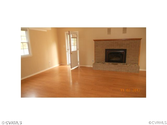 5400 Hair Road Disputanta, VA 23842 - Photo 3 of 7 a open living room with a fireplace