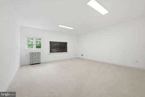 a room with pool table windows and wooden floor