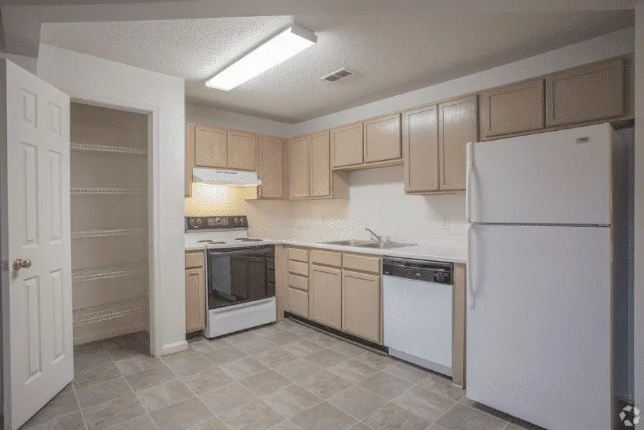 100 Marshview Drive Newport News, VA 23608 - Photo 4 of 15 a kitchen with a refrigerator sink and white cabinets